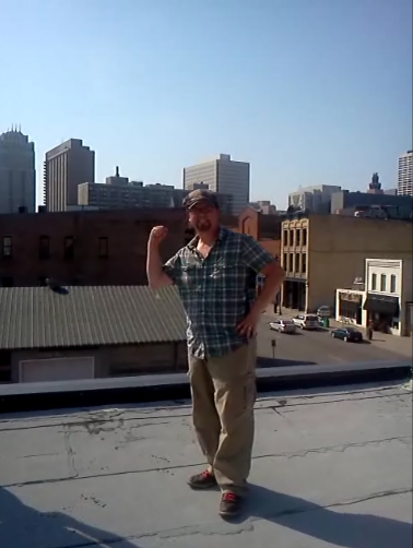 Standing on the roof on top of restaurant where Ecological Gardens is installing a garden